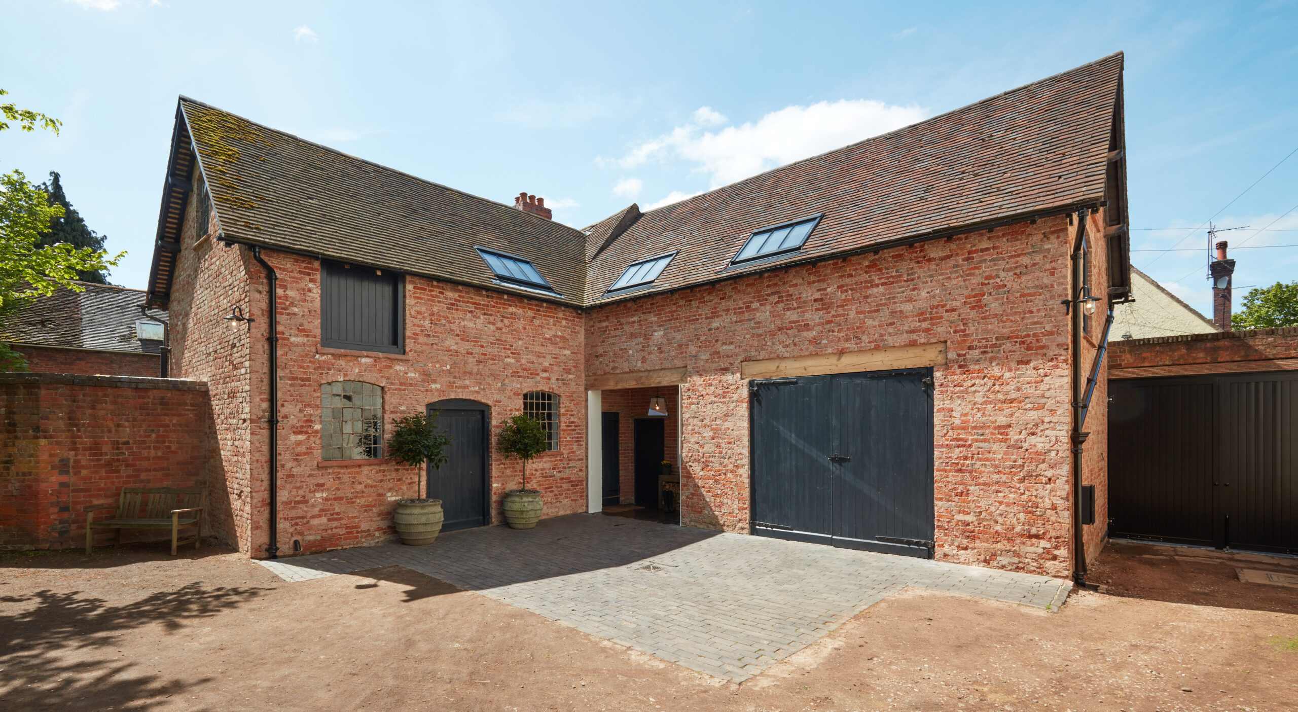 As seen on Saving the Manor, the restored hay loft living room and kitchen and fully restored exterior with oak flooring with underfloor heating, wood paneling and vaulted ceiling.