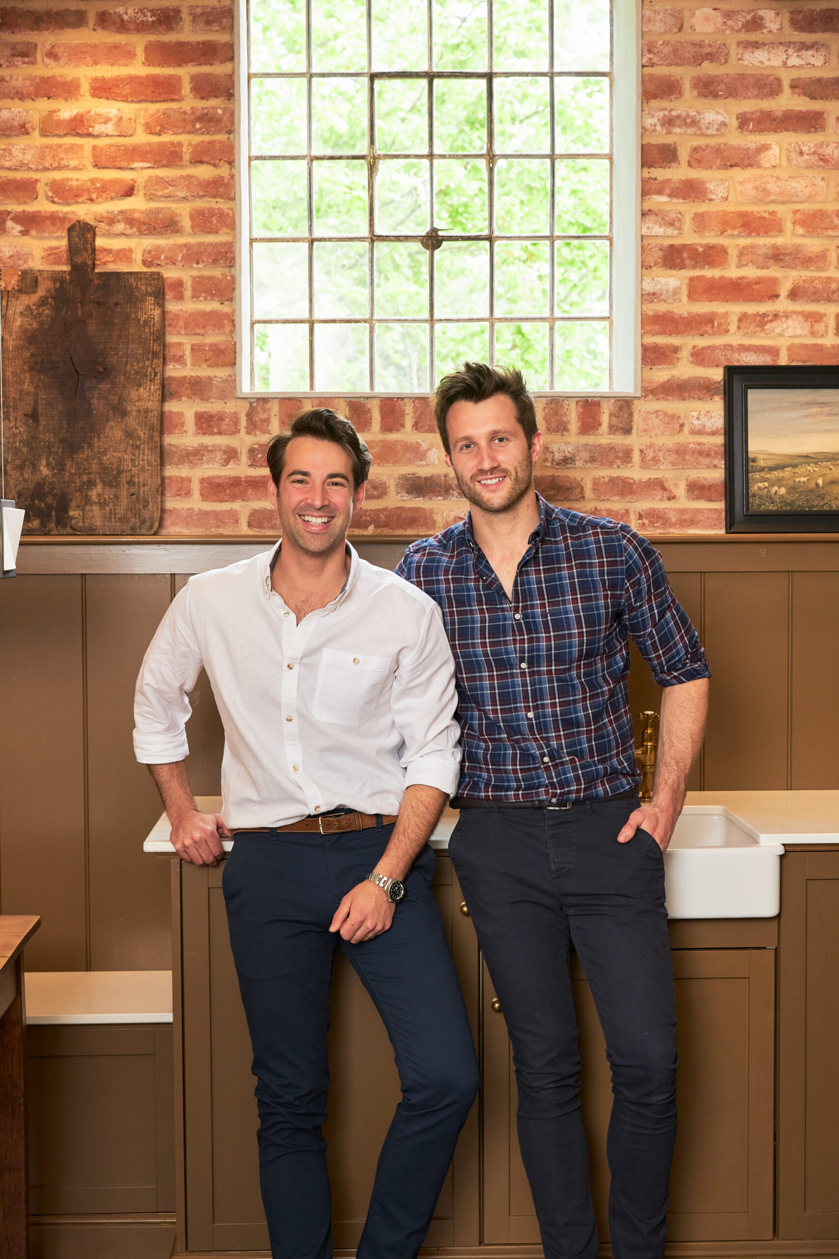 As seen on Saving the Manor homeowners Dean and Borja react to seeing their restored hay loft living room and kitchen and fully restored exterior. Their hay loft kitchen with oak flooring with underfloor heating, wood paneling and vaulted ceiling.
