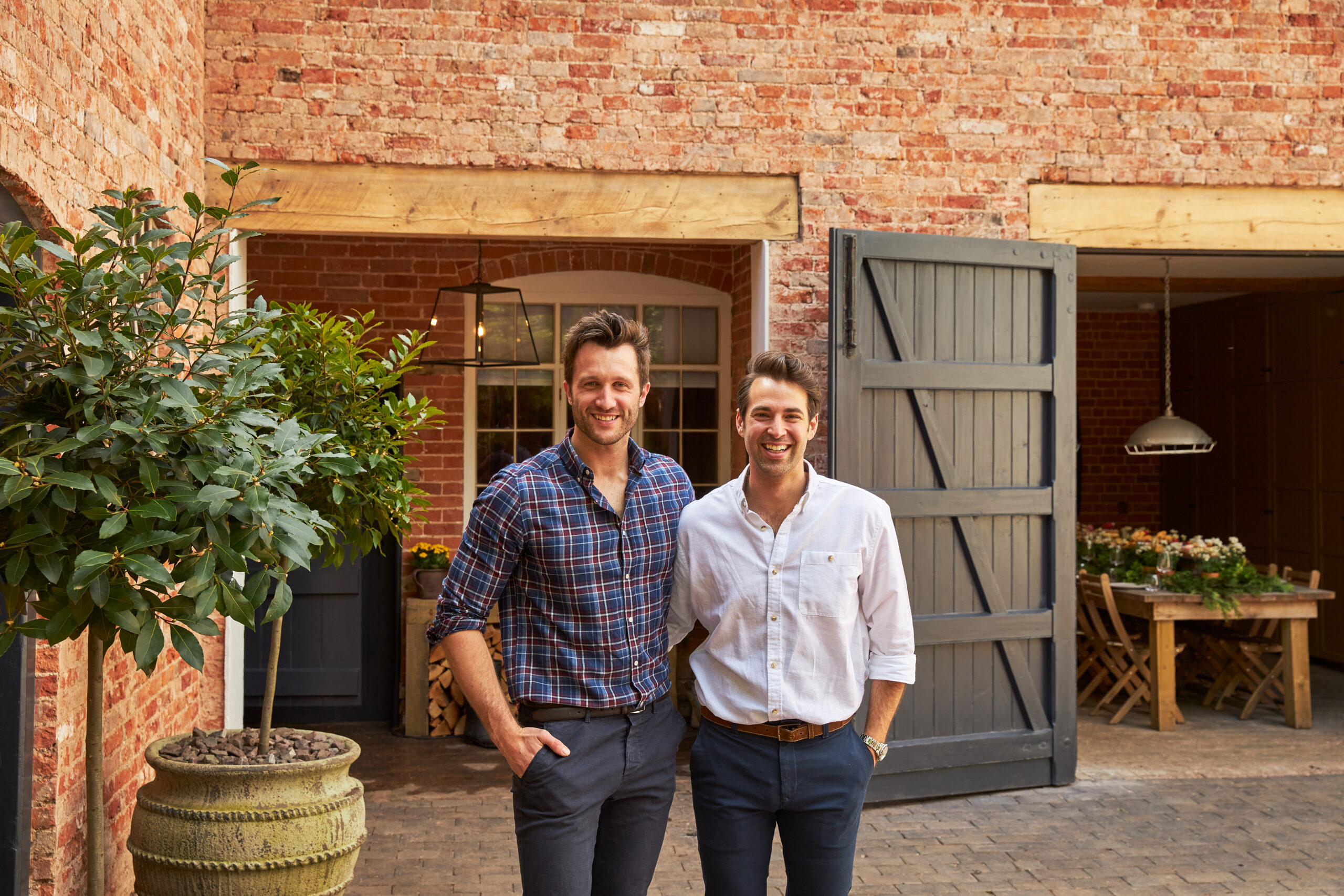 As seen on Saving the Manor homeowners Dean and Borja react to seeing their restored hay loft living room and kitchen and fully restored exterior. Their hay loft kitchen with oak flooring with underfloor heating, wood paneling and vaulted ceiling.
